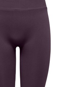 Purple high-waisted leggings made from stretchy fabric, featuring a smooth texture and seamless design around the waist and legs.