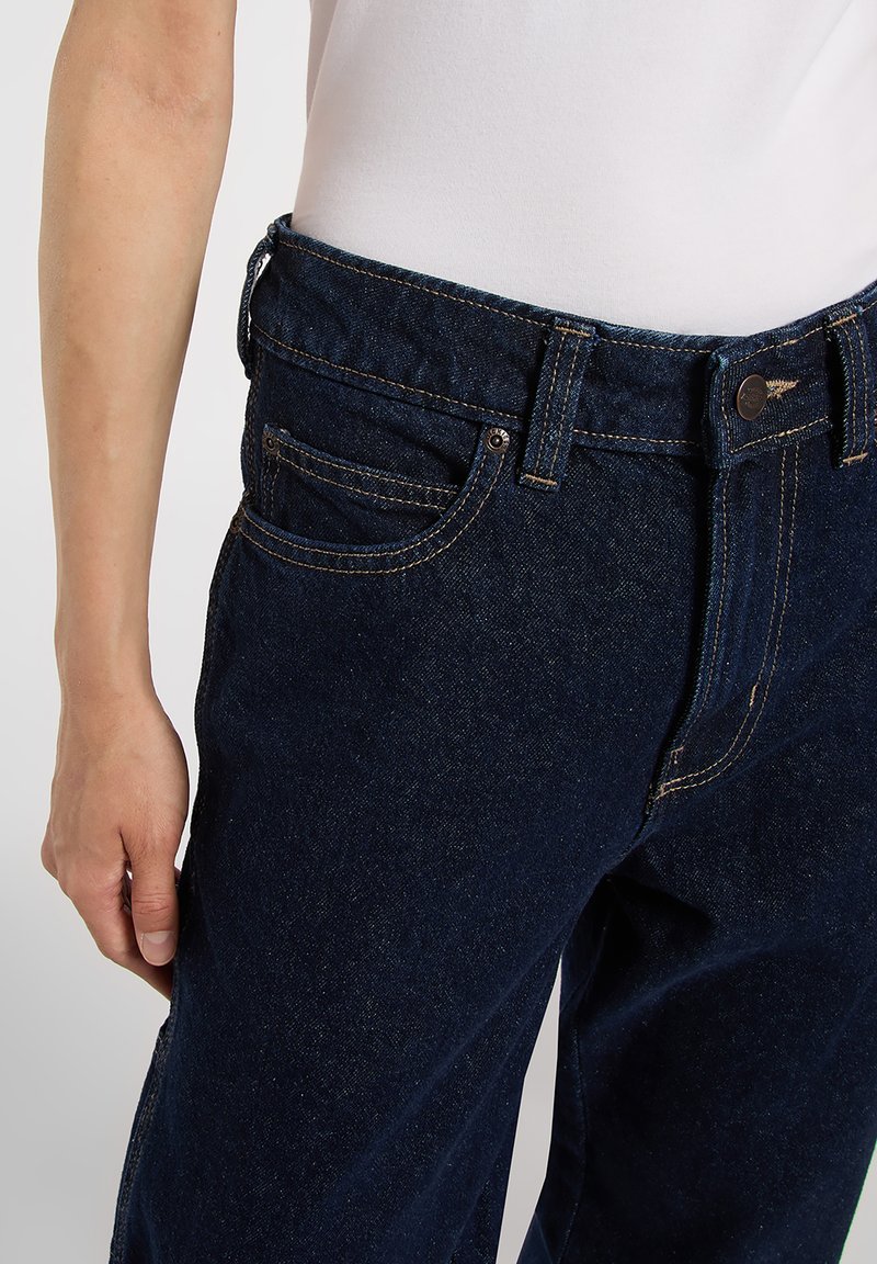 Dark blue denim jeans with a classic design, featuring a straight fit, five-pocket styling, and contrasting yellow stitching.