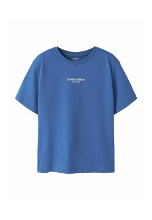 Blue short-sleeve crew neck t-shirt with white text "Studio edition 55°57'03"N" centered on the chest.
