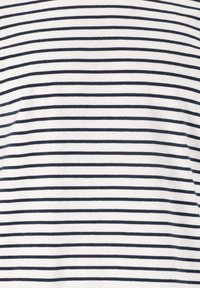 Streepjesshirt met smalle marineblauwe strepen op een witte achtergrond. Gemaakt van zachte, gladde stof met een klassiek horizontaal ontwerp.