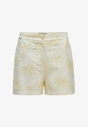 Cremefarbene Shorts mit bestickten Palmenmustern und einem einzelnen dekorativen Knopf am Bund vor weißem Hintergrund.