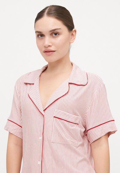 Red and white striped pajama shirt with short sleeves, notch collar, button placket, and front pocket featuring red piping along edges.