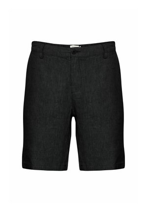 Mustad mustadest linateksad, millel on lame esiosa, vöölukud ja ühekordne nööp. Need sisaldavad tekstureeritud kangast ja kergelt kitsenevaid sääri.