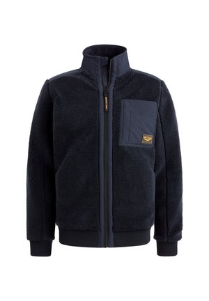 Navy blue fleece jacket with high collar, full zipper, ribbed cuffs, and chest pocket featuring a logo patch. Soft texture and casual design.