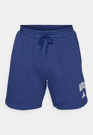 Blå idrettsshorts laget av myk stoff. Har en elastisk midje med snøring og trykket Adidas-logo i hvitt.