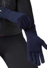 Guanti lavorati a maglia blu navy con polsini a coste, caratterizzati da una superficie liscia e una vestibilità aderente, progettati per calore e destrezza.