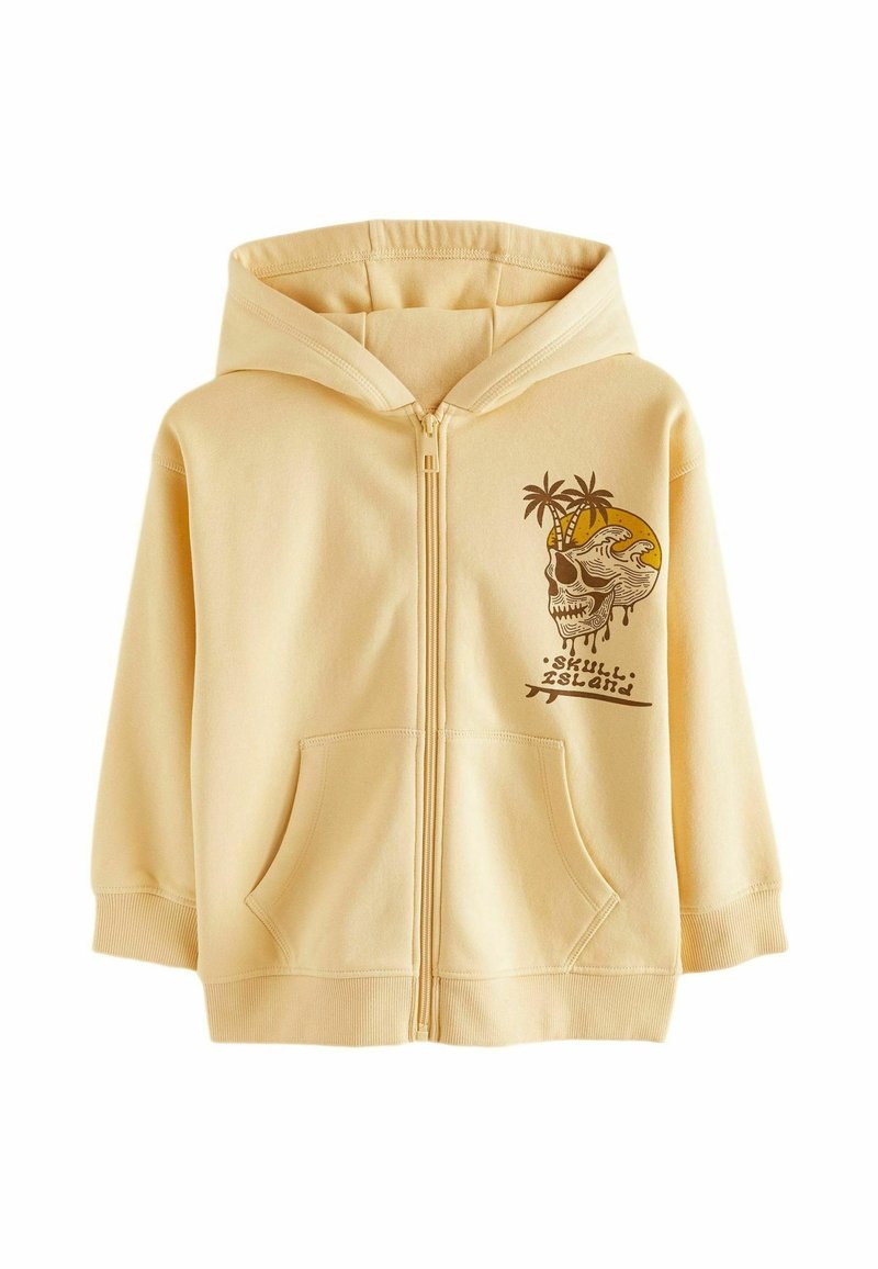 Sweat à capuche beige zippé avec poches avant, présentant un motif de crâne et de palmier avec le texte "skull island" sur la poitrine à gauche.