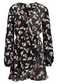 Musta kietaisumekko, jossa on värikäs kukkakuosi, pitkät hihat, röyhelöhelma ja erottuva pilkkupaneeli sivuilla. Valmistettu kevyestä kankaasta.