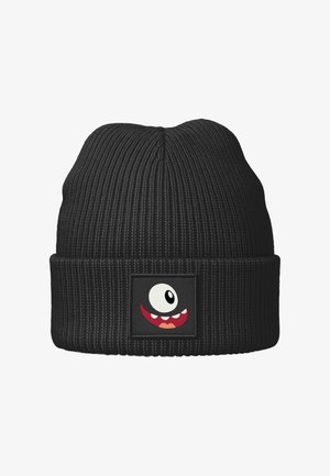 Schwarze gerippte Mütze mit einem umgeschlagenen Bündchen, das ein aufgenähtes Patch mit einem cartoonartigen Monstergesicht zeigt, das ein großes Auge und ein breites Lächeln hat.