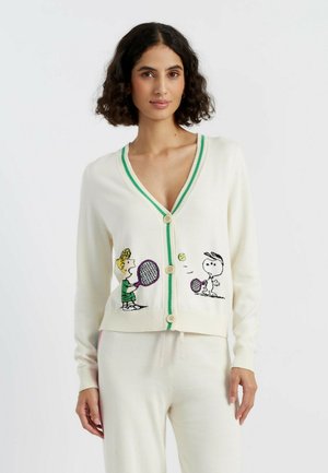Cream cardigan with a deep V-neck, green trim, and wooden buttons, featuring knitted graphics of cartoon characters playing tennis.