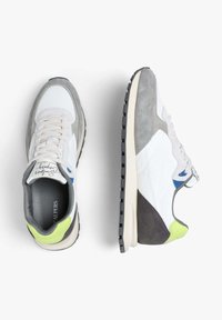 Sneakers with a mix of white nylon, gray suede, blue and lime green accents, featuring a textured black rubber sole and beige midsole.