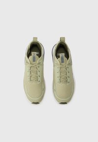 Light green athletic shoes with mesh upper, flat laces, and cushioned sole. Features logo on tongue and heel tab for easy wear.