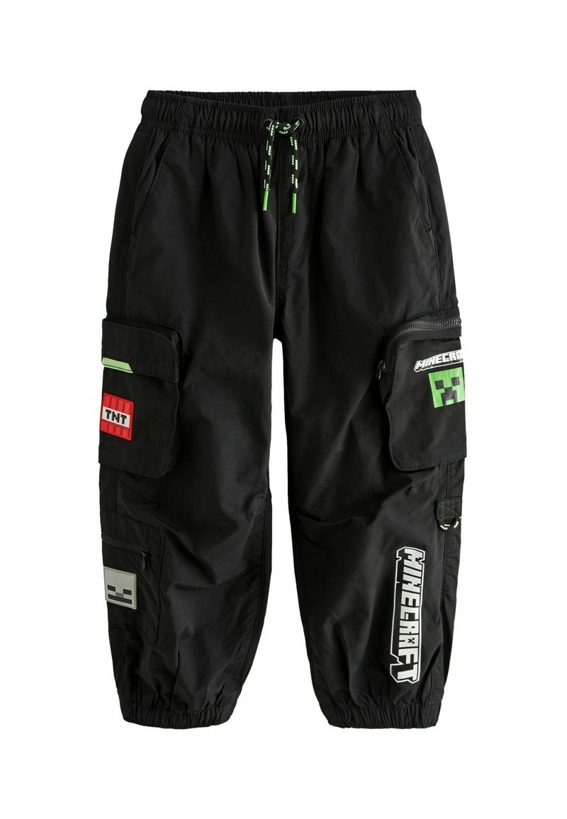Pantalon cargo noir avec taille et poignets élastiques, orné de patchs à thème Minecraft, incluant un bloc TNT et un visage de Creeper, ainsi que des cordons d'ajustement avec accents verts.