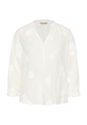 Balta palaidinė su 3/4 rankovėmis, V formos iškirpte ir tekstūruotu gėlių siuvinėjimu. Turi susmulkintus rankogalius ir laisvo silueto kirpimą. Lengva medžiaga.