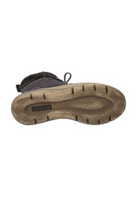 Bota de piel oscura con suela de goma texturizada, que presenta un diseño de cordones, puntera reforzada y costuras en contraste a lo largo de los bordes.