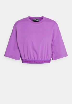 T-shirt cropped viola con maniche corte, orlo elastico stampato con "Versace Jeans Couture" in testo rosso.