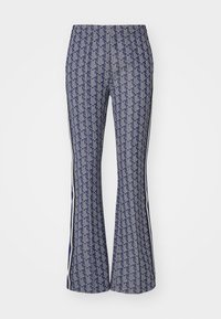 Flared pants with a geometric pattern in navy and white. Elastic waistband, side stripes, and textured fabric throughout.