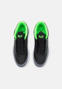 Black athletic shoes with a smooth outer material, bright green inner lining, traditional lacing system, and prominent "23" logo on the tongue.
