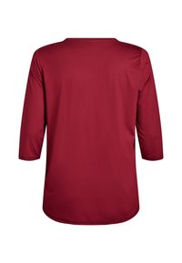 Rotes Langarmshirt mit rundem Ausschnitt und glatter Textur. Verfügt über einen abgerundeten Saum und Dreiviertelärmel.