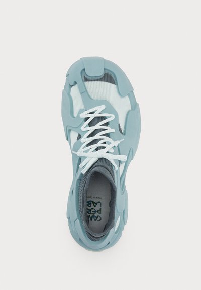 Light blue athletic shoe with textured upper, white laces, and gray accents. Features a unique, contoured design and breathable fabric.