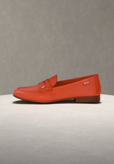 Red leather loafer with wooden sole, stitched detailing, and Polo brand tag on side, displayed on neutral surface against gray background.