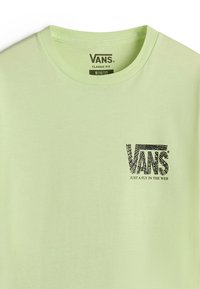 Světle zelené bavlněné tričko s kulatým výstřihem. Na levé části hrudníku má černou grafiku loga Vans. Klasický střih.