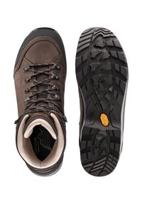 Bruine leren wandelschoenen met een gestructureerde bovenkant, gevoerde enkels en een robuuste zwarte rubberen buitenzool met een kenmerkend profiel.