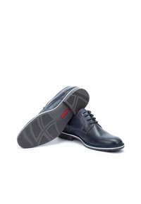Dark blue leather shoes with a smooth finish, lace-up design, white rubber sole, and textured tread pattern. Features red branding on the sole.