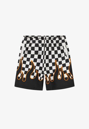 Black and white checkered shorts featuring orange flame patterns at the hem. Elastic waistband with side pockets. Cotton fabric.