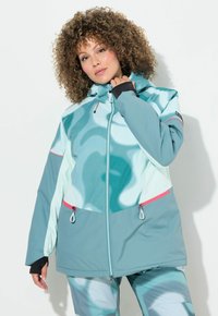 Jasně modrá (teal) a máková (mint) lehká bunda se zipem vpředu, nastavitelnou kapucí a kontrastními růžovými akcenty. Hladký povrch a oversized střih.