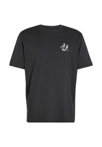 T-shirt en coton noir présentant un graphisme de visage de dessin animé blanc sur le côté gauche de la poitrine, avec une coupe décontractée et un col rond.