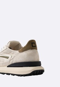 Sneaker beige e marrone con tomaia in suede e tessuto, design minimalista, suola nera e dettaglio logo quadrato sul tallone.