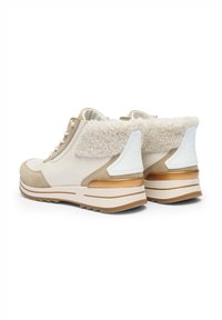 Beige and cream ankle boots with faux fur collar, textured leather and suede, white and gold accents, and a thick rubber sole.