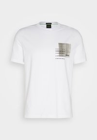 T-shirt en coton blanc avec une poche texturée au motif gris, comprenant des lignes horizontales et verticales, et un petit logo "BOSS".