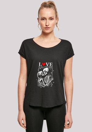 Black short-sleeved T-shirt with a rounded neckline, featuring a graphic print of skeletons embracing, with red and white text.