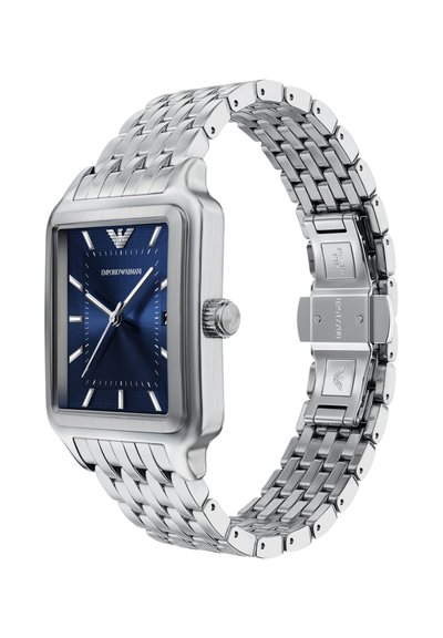 Rechteckige Armbanduhr aus Edelstahl mit blauem Zifferblatt, silbernen Stundenmarkierungen und einem polierten Armband mit strukturierten Gliedern und einer Schließe.