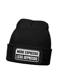 Black knit beanie with folded cuff featuring a patch that reads "MORE ESPRESSO LESS DEPRESSO" in bold black and white text.
