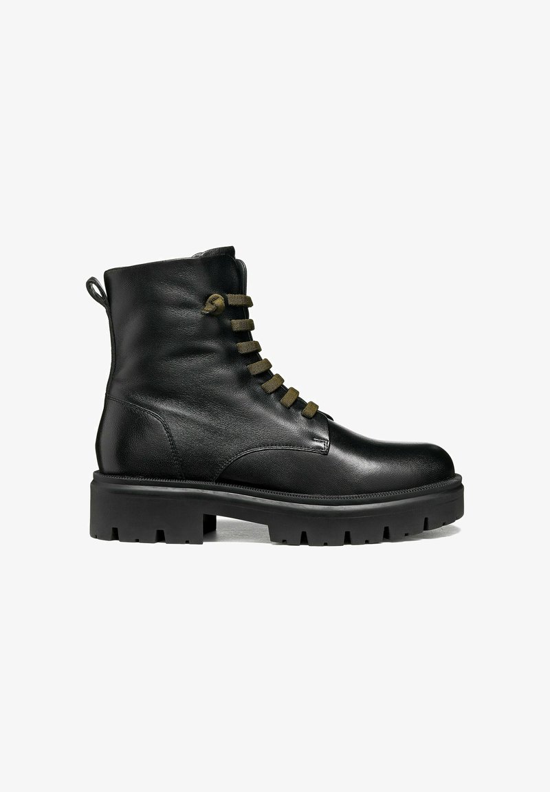Botte de combat en cuir noir avec semelle épaisse et lacets vert olive, vue latérale sur fond blanc.