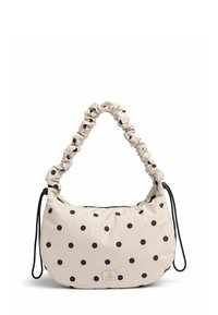 Beige stoftas med rund form, sorte prikker, en samlet strop og lynlåslukning; har et lille logo-plakette.