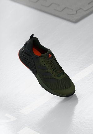 Olive green athletic shoe with black accents, mesh upper, and orange inner lining. Features three black stripes and textured sole.