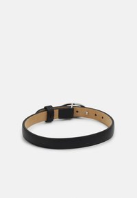 Black leather bracelet with a smooth finish, featuring an adjustable buckle and tan inner lining, secured with silver hardware accents.