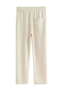 Pantalon beige clair avec une ceinture extensible, une coupe droite, et une seule poche arrière. Confectionné dans un tissu doux et lisse.
