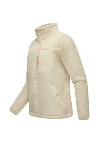 Giacca in pile beige con colletto alto, chiusura a pulsante e due tasche frontali. Presenta un tessuto testurizzato e un design a pannelli a contrasto.