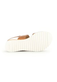 Brown leather sandal with two straps, a contoured footbed, and a white rubber sole featuring horizontal ridges. No visible embellishments.