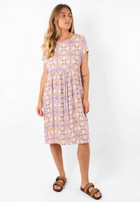 Robe à manches courtes de couleur violet clair, dotée d'un motif floral géométrique. Design évasé avec une coupe ample et une longueur sous le genou.