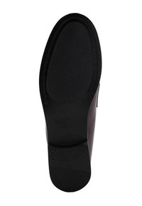 Black shoe outsole featuring a textured rubber design with a smooth, rounded shape. Stitched accents enhance durability.