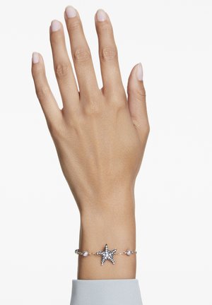 Silver bracelet featuring a starfish pendant adorned with clear crystals and small pearls, set on a delicate chain.