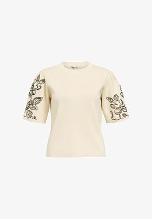 Kremfarget kortermet genser med puffede ermer og svart blomsterbroderi på hver erme.