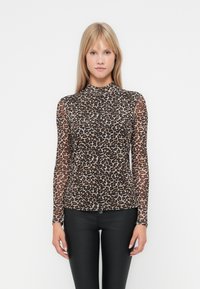 Long-sleeve turtleneck top in sheer brown mesh with a black and tan leopard print pattern, paired with black fitted pants.