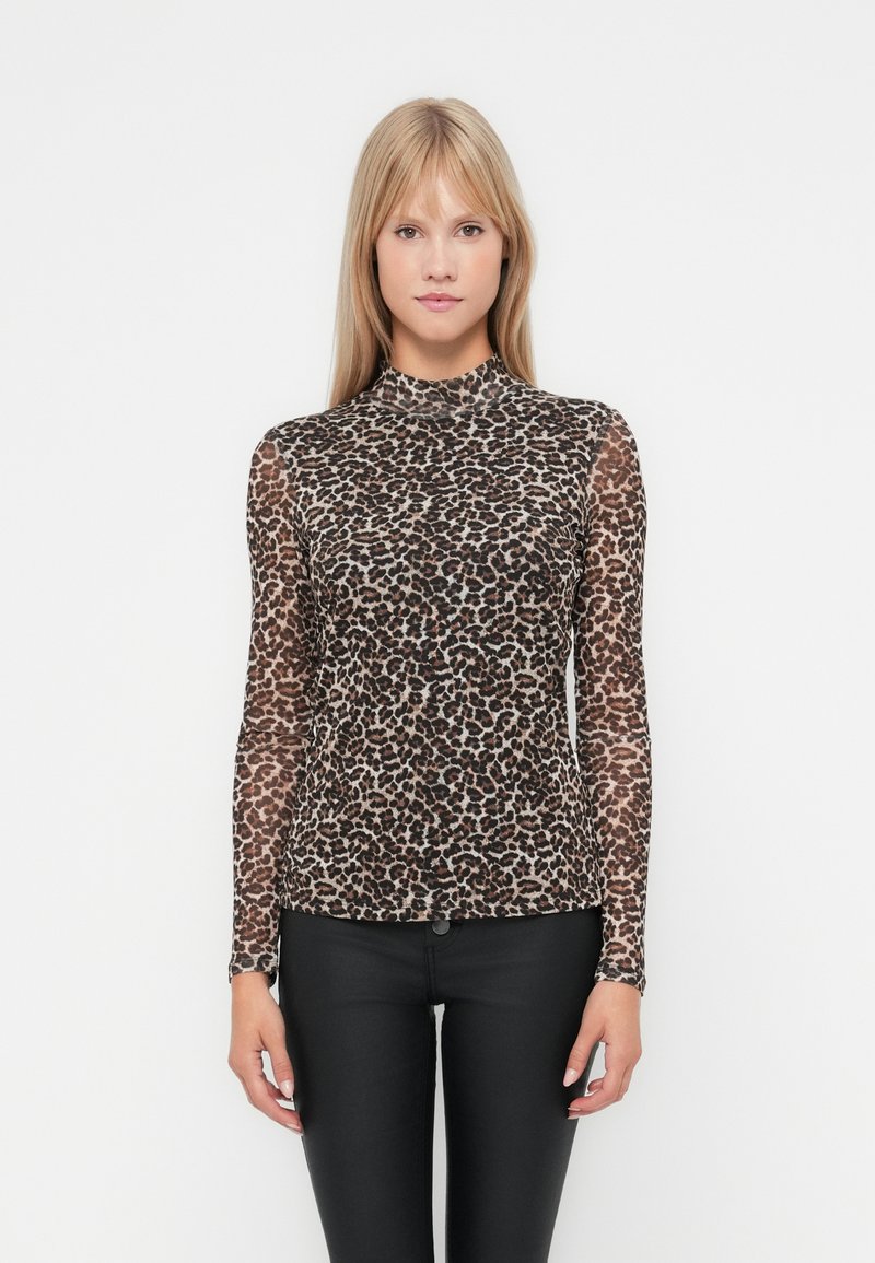 Long-sleeve turtleneck top in sheer brown mesh with a black and tan leopard print pattern, paired with black fitted pants.